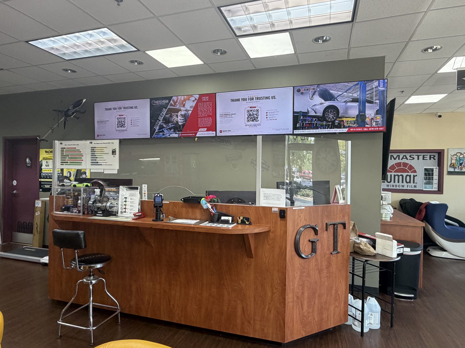 Front desk with GT lettering and service displays at Grand Tires and Arirang Auto Care