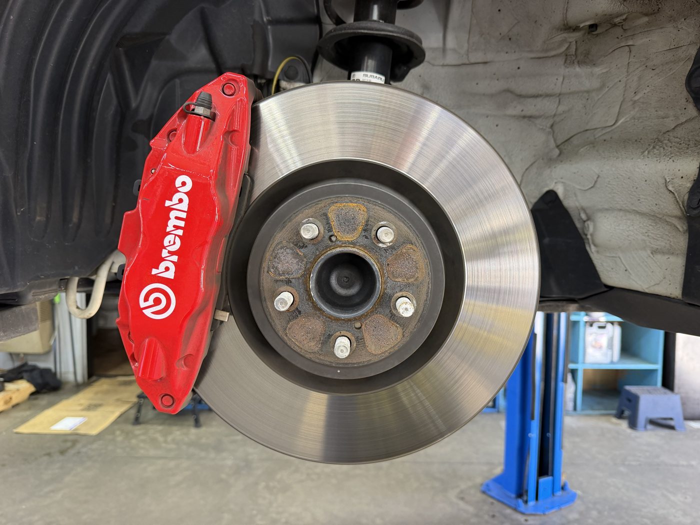 Brake rotor and caliper during a brake job in our shop